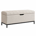 Banco de tela beige con patas de metal y almacenamiento